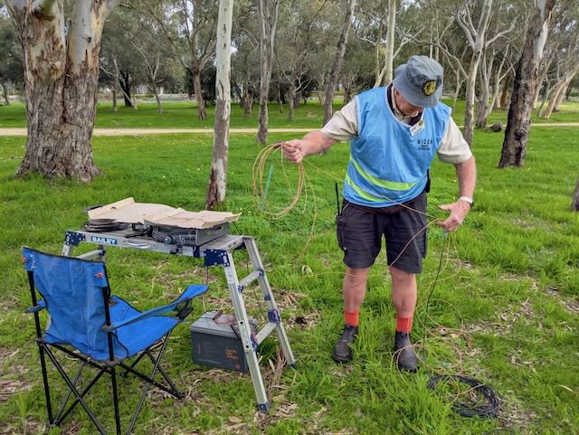 WICEN WA volunteer working with antenna wire and field radio equipment